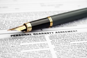 Personal guaranty agreement document with a fountain pen