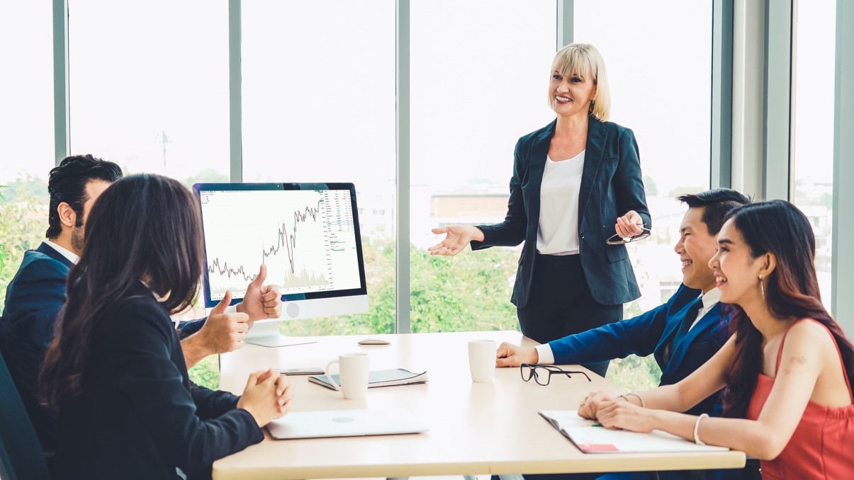 A businesswoman presents a report at an investors’ meeting.