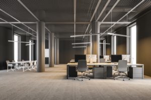 Modern office interior with open floor plan, desks, and conference table. 
