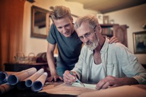 Father and son working on designs