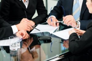 Mixed group of entrepreneurs and business attorneys in a meeting